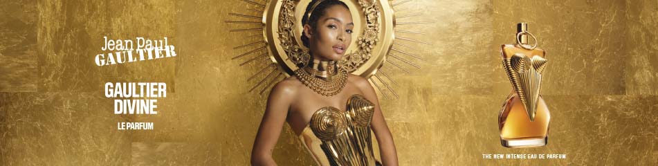 Jean Paul Gaultier Gaultier Divine Le Parfum Werbekampagne mit einer eleganten Frau in einem goldenen Korsett, umgeben von einer goldenen Aura, neben dem luxuriösen Parfumflakon.